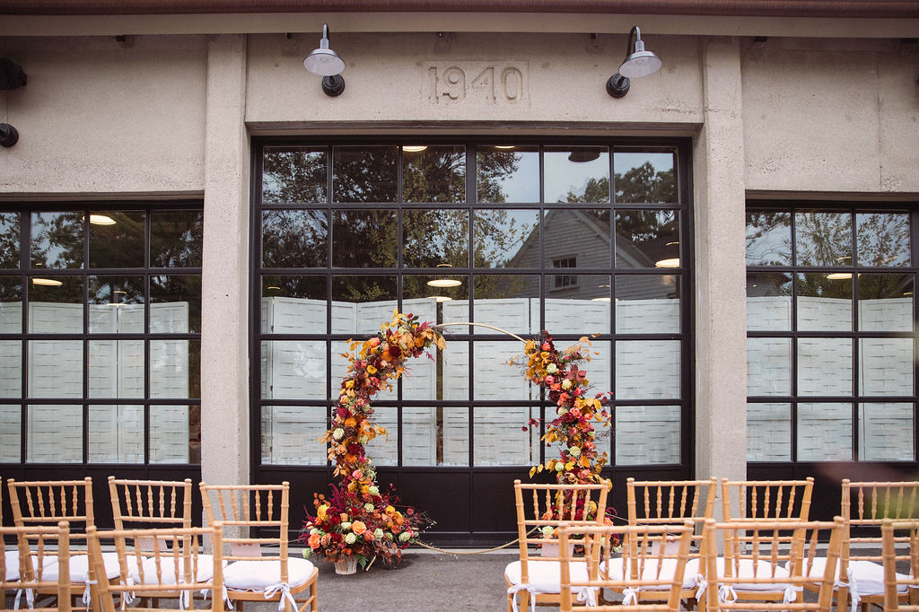 an outdoor wedding venue with a floral arch