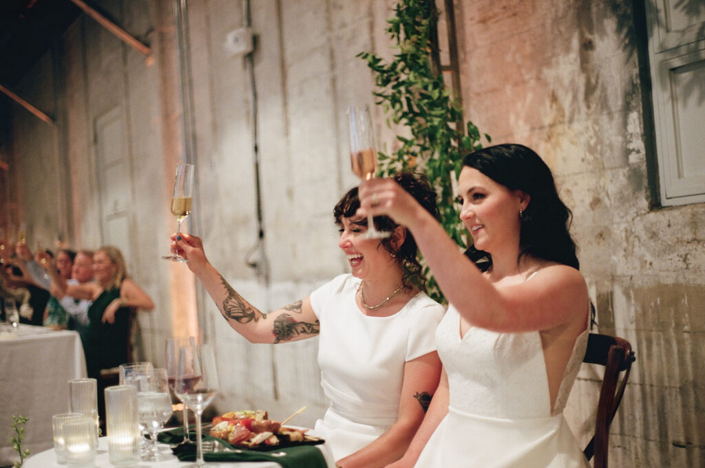 A couple toasts their guests at the Garage B wedding event venue