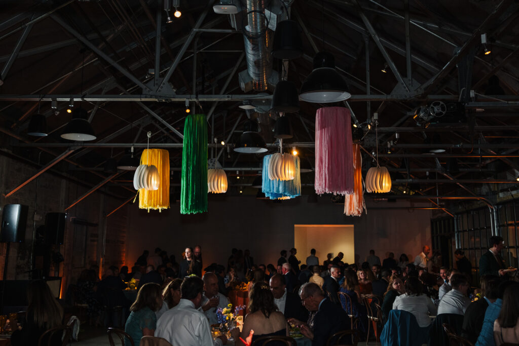 Colorful lanterns hang from the ceiling of Garage B, a wedding venue in the Greater Boston area