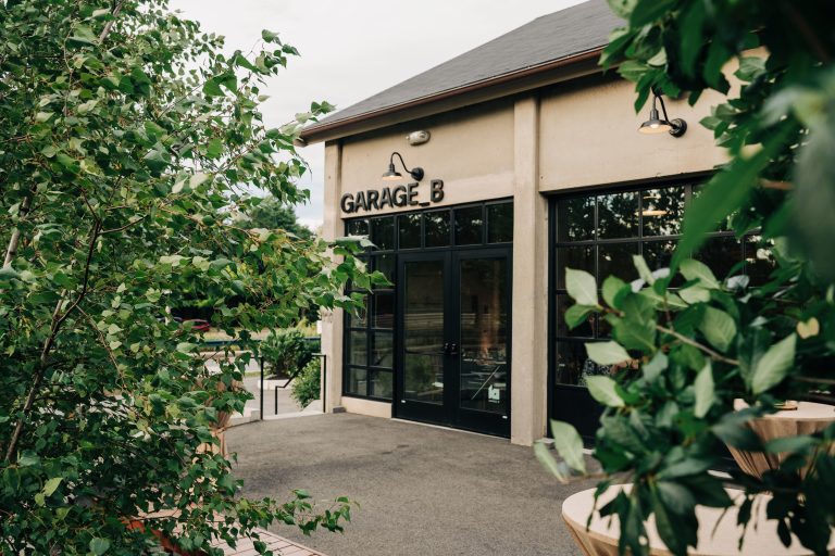 A portion of Garage B's exterior and it's adjacent patio.