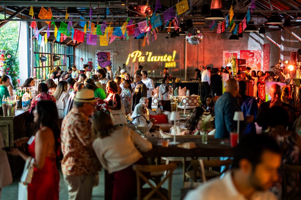 A gala celebrating Latin culture in a warehouse-style venue.
