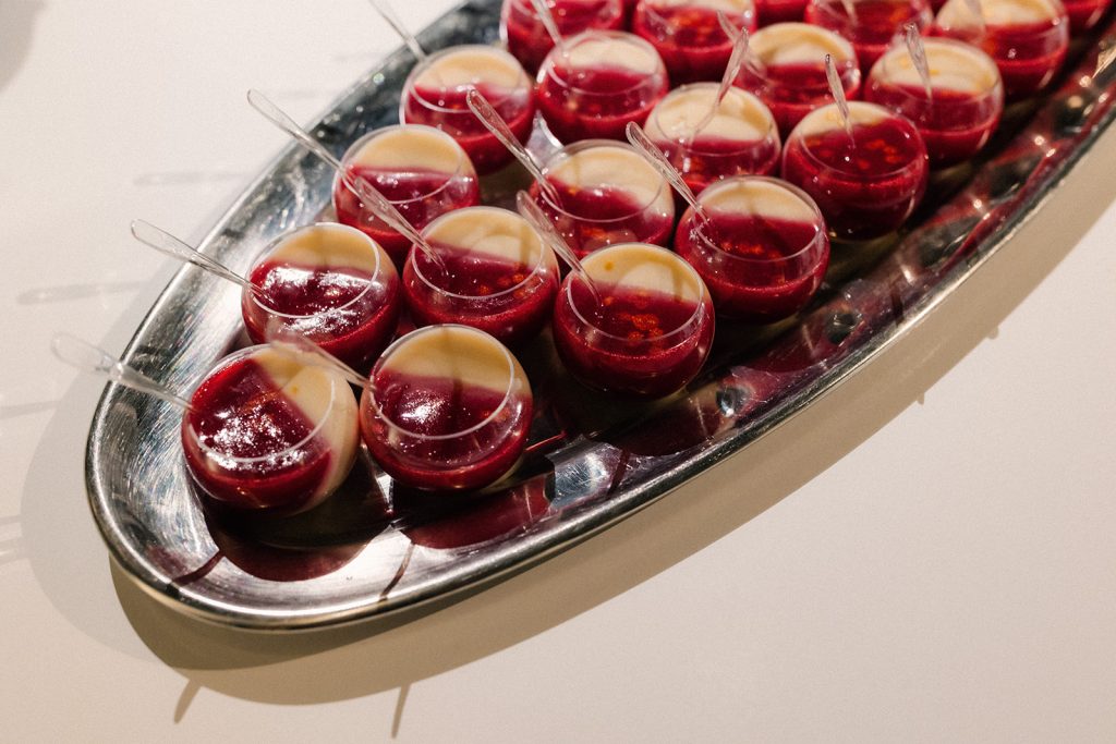 A tray of gelatin-and-custard desserts in miniature cups.